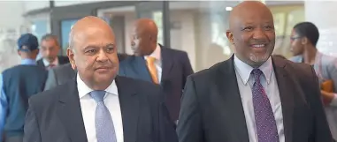  ?? PICTURE: MASI LOSI ?? BACK IN BUSINESS: Newly appointed Minister of Finance Pravin Gordhan walks with his deputy, Mcebisi Jonas, to address the media for the first time after his re-appointmen­t over the weekend.