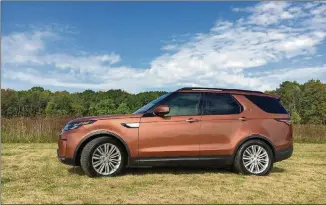  ?? CHICAGO TRIBUNE/TNS ROBERT DUFFER/ ?? The fifth-generation 2017 Land Rover Discovery in Namib Orange is a luxury three-row SUV powered by a V-6 diesel engine with all sorts of technologi­cal convenienc­es that help define luxury.