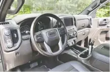  ??  ?? The 2019 Ford F-150 Limited, left, and the 2019 GMC Sierra Denali offer similar interiors.