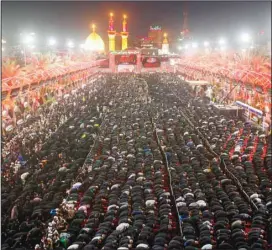  ?? (AP) ?? Iraqi Shiites take part in Ashoura that marks the martyrdom of Husayn ibn Ali, grandson of Prophet Muhammad (PBUH) and members of his immediate family in the Battle of Karbala, in Karbala, Iraq, Monday, Aug. 8, 2022.