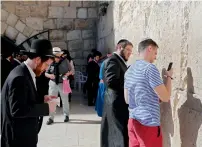  ??  ?? Jews pray at the Western Wall in the Old City of Jerusalem .—