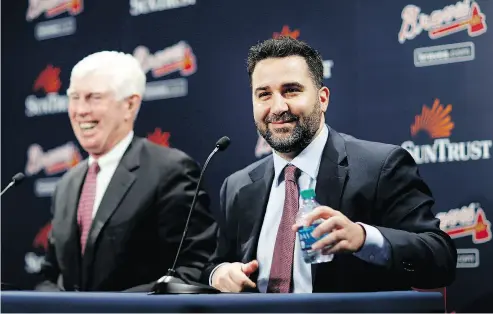  ?? DAVID GOLDMAN/AP PHOTO ?? Atlanta Braves executive Alex Anthopoulo­s, right, says he still follows the Toronto Blue Jays as closely as he can.