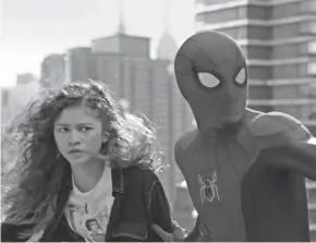  ?? SONY PICTURES ?? MJ (Zendaya) and Spider-man (Tom Holland) are surrounded by unwanted media attention in “Spider-man: No Way Home.”