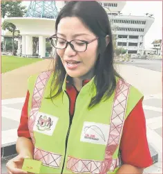  ??  ?? Davina shows the reflective sticker to be placed below the number plate of a motorcycle so that it can easily be visible to other vehicles especially heavy vehicles like lorries and buses 50 metres away.