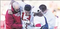  ?? Wesley Hitt / TNS ?? Alabama QB Tua Tagovailoa (13) is helped off the field after an injury on Nov. 16 in Starkville, Miss.