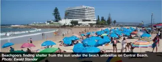  ?? ?? Beachgoers finding shelter from the sun under the beach umbrellas on Central Beach. Photo: Ewald Stander