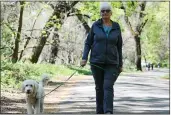  ?? MATT BATES — ENTERPRISE-RECORD ?? Marilyn Quinn walks her dog Izzy through Bidwell Park on Wednesday in Chico.