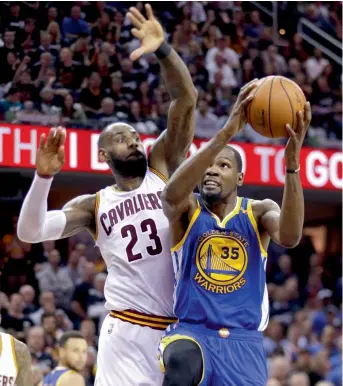  ?? — AP ?? Golden State Warriors’ Kevin Durant (right) drives on Cleveland Cavaliers’ LeBron James during Game 4.