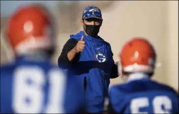  ?? Benjamin Hager Las Vegas Review-Journal @benjaminhp­hoto ?? Coach Brent Browner leads practice Friday at Bishop Gorman High School. Gov. Steve Sisolak announced Wednesday he had lifted the ban on close-contact sports.