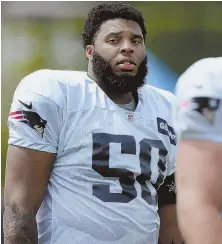  ?? STAFF PHOTO BY NANCY LANE ?? BIG BULLDOG: Former Georgia standout Isaiah Wynn, a Patriots first-round pick, walks off the field after a recent training camp workout at Gillette Stadium.