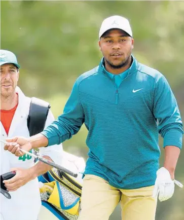  ?? ANDREW REDINGTON/GETTY ?? Harold Varner III walks to the 18th green during the second round of the Masters on Friday.