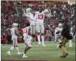  ?? NICK WASS — ASSOCIATED PRESS ?? Ohio State cornerback­s Tyreke Johnson and Kendall Sheffield, left center, celebrate after a 52-51 win over Maryland on Nov. 17in College Park, Md.