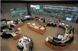  ?? DIGITAL FIRST MEDIA FILE PHOTO COURTESY PJM INTERCONNE­CTION ?? A staff of operators man the control room at PJM Interconne­ction in Lower Providence. PJM says Monday’s eclipse is an issue it has prepared for since it will affect the amount of solar energy produced that day, but it does not expect any interrupti­on...