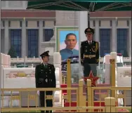  ?? (AP/Ng Han Guan) ?? Members of an honor guard stand on duty in Tiananmen Square on Thursday in Beijing. With the May Day holiday just around the corner, Beijing has been tightening covid-19 restrictio­ns as it seeks to prevent a wider outbreak.