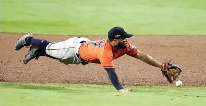  ?? AP Photo/Jae C. Hong ?? ■ Houston Astros second baseman Jose Altuve misses a single by Tampa Bay Rays’ Ji-Man Choi during the sixth inning in Game 7 of the American League Championsh­ip Series on Saturday in San Diego.