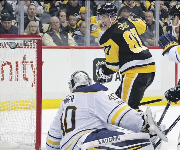  ?? GENE J. PUSKAR/THE ASSOCIATED PRESS ?? Pittsburgh Penguins centre Sidney Crosby lifts the puck over Buffalo Sabres goaltender Robin Lehner for a goal in the second period of Tuesday’s game in Pittsburgh. The goal ended an 11-game stretch in which the 30-year-old could not find the back of...