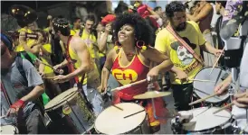  ?? LEO CORREA, THE ASSOCIATED PRESS ?? A woman drums at a street party in Rio de Janeiro, Brazil. Unlike the official carnival parades at the Sambadrome, street parties are free.