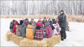  ?? JONATHAN HAYWARD/THE CANADIAN PRESS ?? Adam Herold’s father Russell (right) pauses for a moment as he speaks to Adam’s friends at a gathering to mourn his death, but to also celebrate what would have been Adam’s 17th birthday in Montmartre, Sask. on Thursday, April 12.