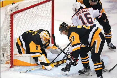  ?? The Associated Press ?? Pittsburgh Penguins goaltender Casey DeSmith blocks a shot by Edmonton Oilers’ Derick Brassard during an NHL game in Pittsburgh on April 26.