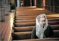  ?? ZBIGNIEW BZDAK/CHICAGO TRIBUNE 2018 ?? Jessica Santiago, 34, prays after Sunday Mass at St. Ita Catholic Church in Edgewater, which is likely to merge with another parish.