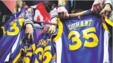  ?? Gabrielle Lurie / The Chronicle ?? You are assuredly a bandwagon fan if the first Warriors jersey you bought has the name “Durant” on the back.