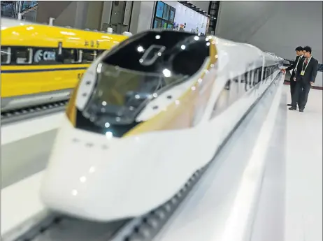  ?? Picture: XINHUA ?? Two visitors look at models of China’s standardis­ed electric multiple units at the stand of China Railway. Twenty-two African countries and more than 30 South African companies participat­ed in the China-Africa Equipment Manufactur­ing Industry Exhibition.