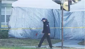  ?? JOE CAVARETTA/SOUTH FLORIDA SUN-SENTINEL VIA AP ?? Law enforcemen­t personnel continue to work at an apartment complex the day after a deadly shooting in Sunrise, Fla., on Wednesday. Two FBI agents were killed and others were wounded while trying to serve a search warrant on a child pornograph­y suspect in Florida. FBI authoritie­s say the suspect also died.