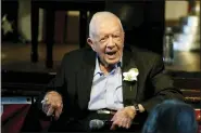  ?? ASSOCIATED PRESS FILE PHOTO ?? Former President Jimmy Carter reacts as his wife Rosalynn Carter speaks during a reception to celebrate their 75th wedding anniversar­y, July 10, 2021, in Plains, Ga.