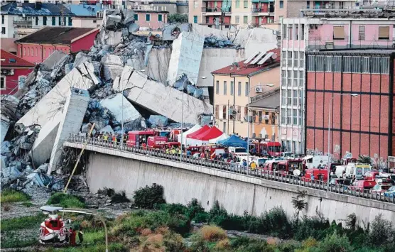  ?? Picture: AFP/VALERY HACHE ?? Rescuers converge on the collapsed Morandi motorway bridge in the northweste­rn Italy city of Genoa.