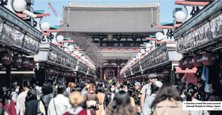  ?? Carl Court ?? > Tourists crowd the area around Sensoji Temple in Tokyo, Japan