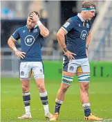  ??  ?? Scotland were disconsola­te after losing to Ireland on Sunday.