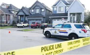  ?? JASON PAYNE/PNG ?? Police blocked off an area in the 13900-block of 58A Avenue in Surrey after a man was shot to death on Friday. A white Mercedes was seen leaving the area.