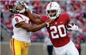  ?? AP FILE PHOTO BY TONY AVELAR ?? In this Saturday, Sept. 8, photo, Stanford running back Bryce Love (20) stiff-arms Southern California cornerback Iman Marshall (8) during the first half of an NCAA college football game in Stanford, Calif.