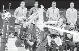  ??  ?? VakifBank’s Naz Aydemir Akyol (10) smashes the ball through the defense of Vitra’s Jordan LarsonBurb­ach and Thaisa Daher Palessi (6).