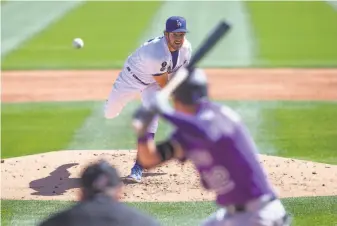  ?? Rob Tringali / Getty Images ?? Starting pitcher Trevor Bauer, who won the NL Cy Young Award with the Reds last year, made his first Dodgers appearance since signing a $102 million, threeyear contract in the offseason.