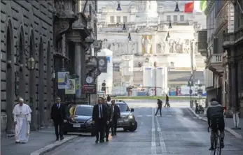  ?? Vatican News via AP ?? Pope Francis walks Sunday to reach St. Marcel on the Corso church in Rome. The church keeps a “miraculous crucifix that in 1522 was carried in procession through the neighborho­ods of the city so that the Great Plague of Rome ended,” a Vatican spokesman said.