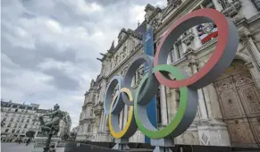  ?? AP File photo ?? The Olympic rings are seen in front of the Paris City Hall.