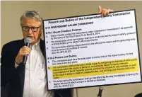  ?? CLYDE MUELLER/THE NEW MEXICAN ?? Prior to taking public comments, Paul Hultin, chairman of the Independen­t Salary Commission, holds a graphic as he explains the charter the commission followed to make recommenda­tions for a proposed salary for a full-time mayor of Santa Fe.