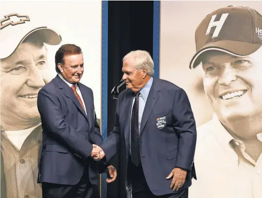  ?? JARED C. TILTON, GETTY IMAGES ?? NASCAR team owners Richard Childress, left, and Rick Hendrick shake hands after receiving their Hall of Fame jackets before the Class of 2017 induction ceremony Friday.