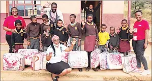  ?? ?? Pupils from Mbuluzi Primary School with their blankets donated by the Times of Eswatini.