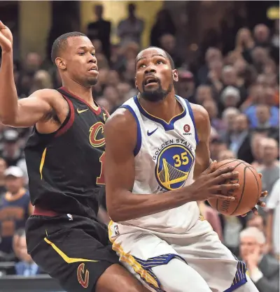 ?? KEN BLAZE / USA TODAY SPORTS ?? Warriors forward Kevin Durant drives against Cavaliers guard Rodney Hood on Wednesday night at Quicken Loans Arena. Durant scored 43 points.