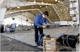  ?? TY GREENLEES / STAFF ?? Kevin Newbold from Cincinnati Bell checks the Wi-Fi system he helped install at the Warren County Fairground­s in Lebanon where President Trump will visit today to hold a rally.