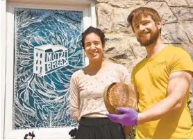  ?? AMY DAVIS/BALTIMORE SUN ?? Maya Muñoz and Russell Trimmer have launched Motzi Bread at the corner of Guilford Avenue and East 28th Street, where a neighborho­od drugstore once stood.