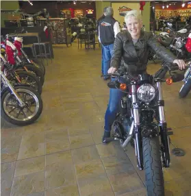  ??  ?? BIKER. Samantha Kay poses for a photo on a 2017 Harley Sportster Forty-Eight in Milwaukee’s House of Harley. Kay took a riding course at the dealership as part of HarleyDavi­dson’s “Riding Academy,” an initiative the company hopes will help bring new...