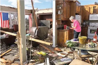  ?? AP PHOTOS/JAY REEVES ?? Patti Herring sobs while sorting through the remains of her Fultondale, Ala., home on Tuesday.