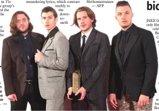  ?? — AFP file photo ?? Turner (left to right), Jamie Cook, Nick O’Malley and Matt Helders of Arctic Monkeys pose with their Albums of the Year trophy at the 2013 Mercury Prize awards ceremony.