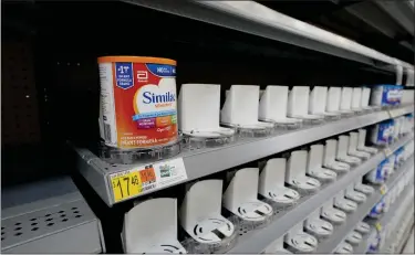  ?? AP ?? Shelves typically stocked with baby formula sit mostly empty at a store in San Antonio, Tuesday. Parents across the U.S. are scrambling to find baby formula because supply disruption­s and a massive safety recall have swept many
leading brands off store shelves.