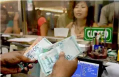  ??  ?? The ringgit has the potential to appreciate to 3.9 against the US dollar this year, given the weaker greenback and steady global oil prices, an analyst says. — AFP photo