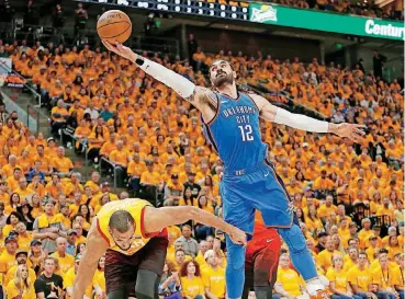  ?? [AP PHOTO] ?? Oklahoma City’s Steven Adams, right, reaches for a rebound over Utah’s Rudy Gobert during Saturday night’s playoff game in Salt Lake City.