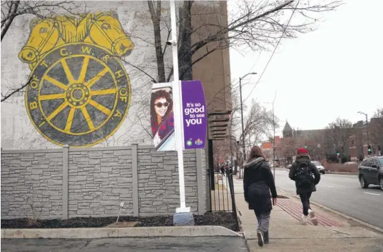  ?? SCOTT OLSON/GETTY IMAGES ?? People walk past a Teamsters sign on Friday in Chicago. Public-sector workers, like police and teachers, have the highest unionizati­on rates.